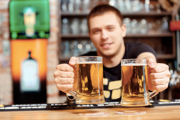 Barman with glasses of beer