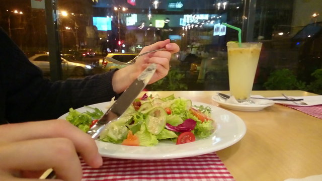 Guy enjoying appetizing salad, eating out, having low-fat dinner