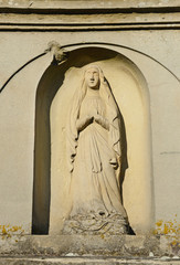 Cara stone statue on the tombstone in the cemetery in Ukraine