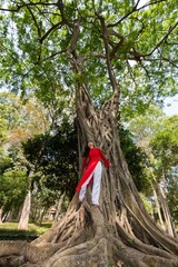 Asian woman in a fig tree