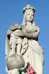 Old stone statue of the Virgin on tomb and Jesus Christ with rol