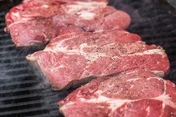 Fresh beef steaks on grill or BBQ