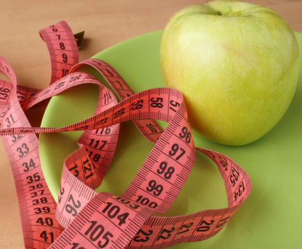 Apple and measuring tape. Diet concept.