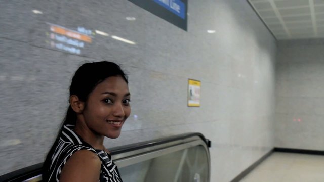 woman rides the escalator in the metro