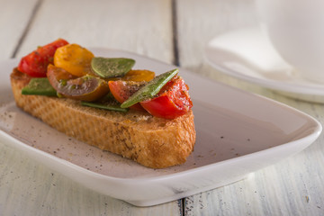 Spring Bruschetta with tomatoes and young green peas