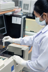 Woman test blood on biochemistry automate