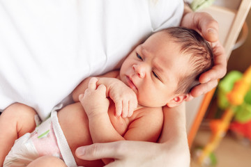 newborn baby in the arms of my mother, close-up