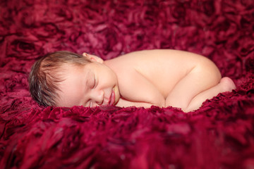 Obraz na płótnie Canvas newborn baby sleeping in a baby cot
