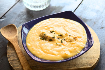 Thick yellow split pea soup with chicken and oregano