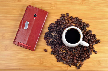 cup of coffee and phone and coffee beans