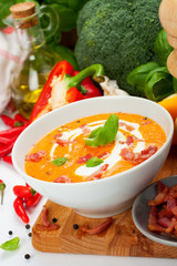 Carrot sweet pepper cream soup with bacon