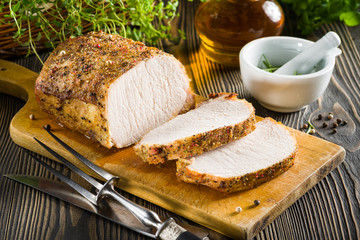 Roasted pork loin on the wooden table