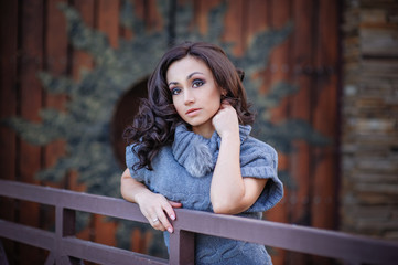 Beautiful girl on a background of wooden gates