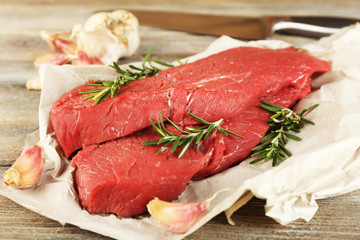 Raw beef steak with rosemary and garlic
