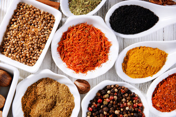Different kinds of spices in ceramics spoons, close-up,