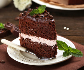 Delicious chocolate cake on table close-up
