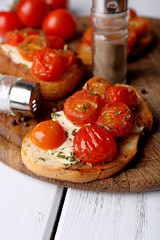 Slices of white toasted bread with butter and canned tomatoes