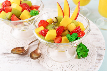 Fruit salad with mint and orange juice in glassware