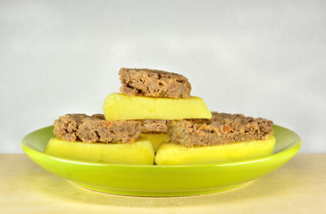 Boiled meat and potatoes in a green plate