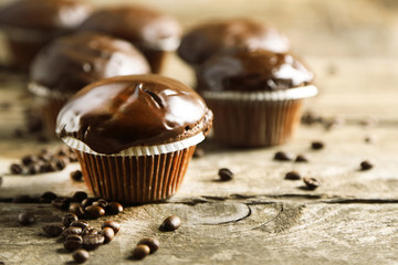 Tasty homemade chocolate muffins on wooden table