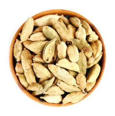 Cardamom in wooden bowl, isolated on white