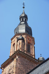 Fototapeta na wymiar Clock tower and spire of Cathedral of Holy Spirit in Heidelberg