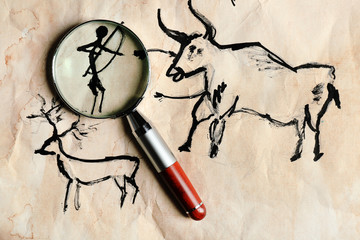 Rock paintings with magnifier on paper close up