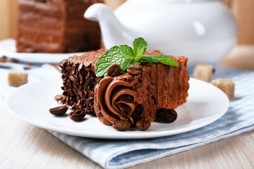 Tasty piece of chocolate cake with mint and cinnamon