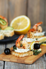 Appetizer canape with shrimp and olives