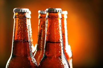 Glass bottle of beer on dark background