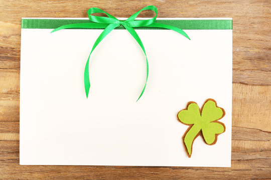 Greeting card for Saint Patrick's Day on wooden table