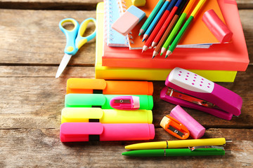 Bright school stationery on old wooden table