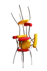 Stack of colorful chairs isolated on white