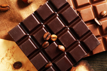 Delicious chocolates with nuts spices on table, closeup