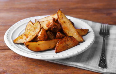 Baked potatoes on pate on wooden table