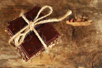 Stack of tied chocolate on wooden background