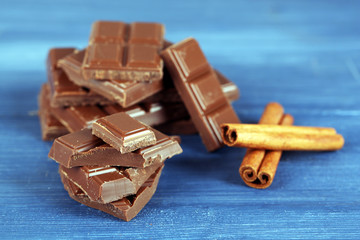 Pieces of chocolate with cinnamon sticks