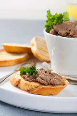 Chicken liver pate on bread and in bawl