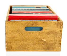 Books in wooden box isolated on white