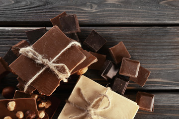 Set of chocolate with hazelnut on wooden table, closeup