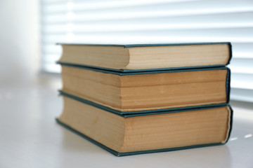 Books on white windowsill, close up