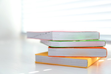 Books on white windowsill, close up