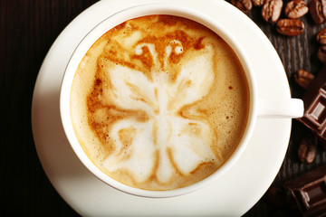 Cup of latte art coffee, closeup