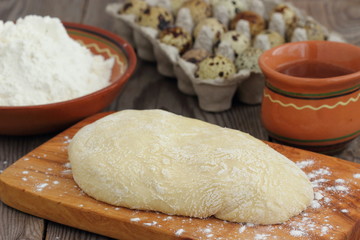 speckled quail eggs and flour on a rustic wooden background