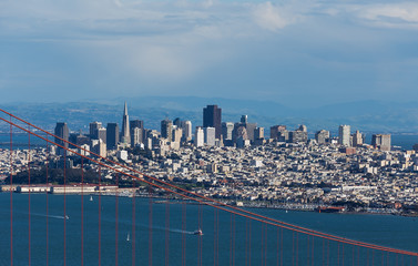 San Francisco downtown looking through cables of Golden Gate bri