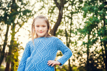 Portrait of a cute little girl on sunset