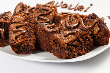 Chocolate brownies on white plate