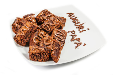 Chocolate brownies on white plate