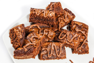 Chocolate brownies on white plate