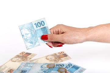 Woman's hand and Brazilian money